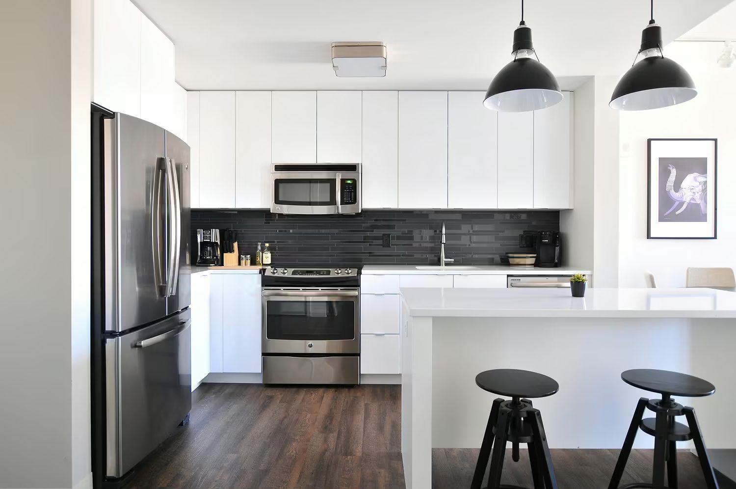 A spotless move-in-ready kitchen with stainless appliances and white cabinets