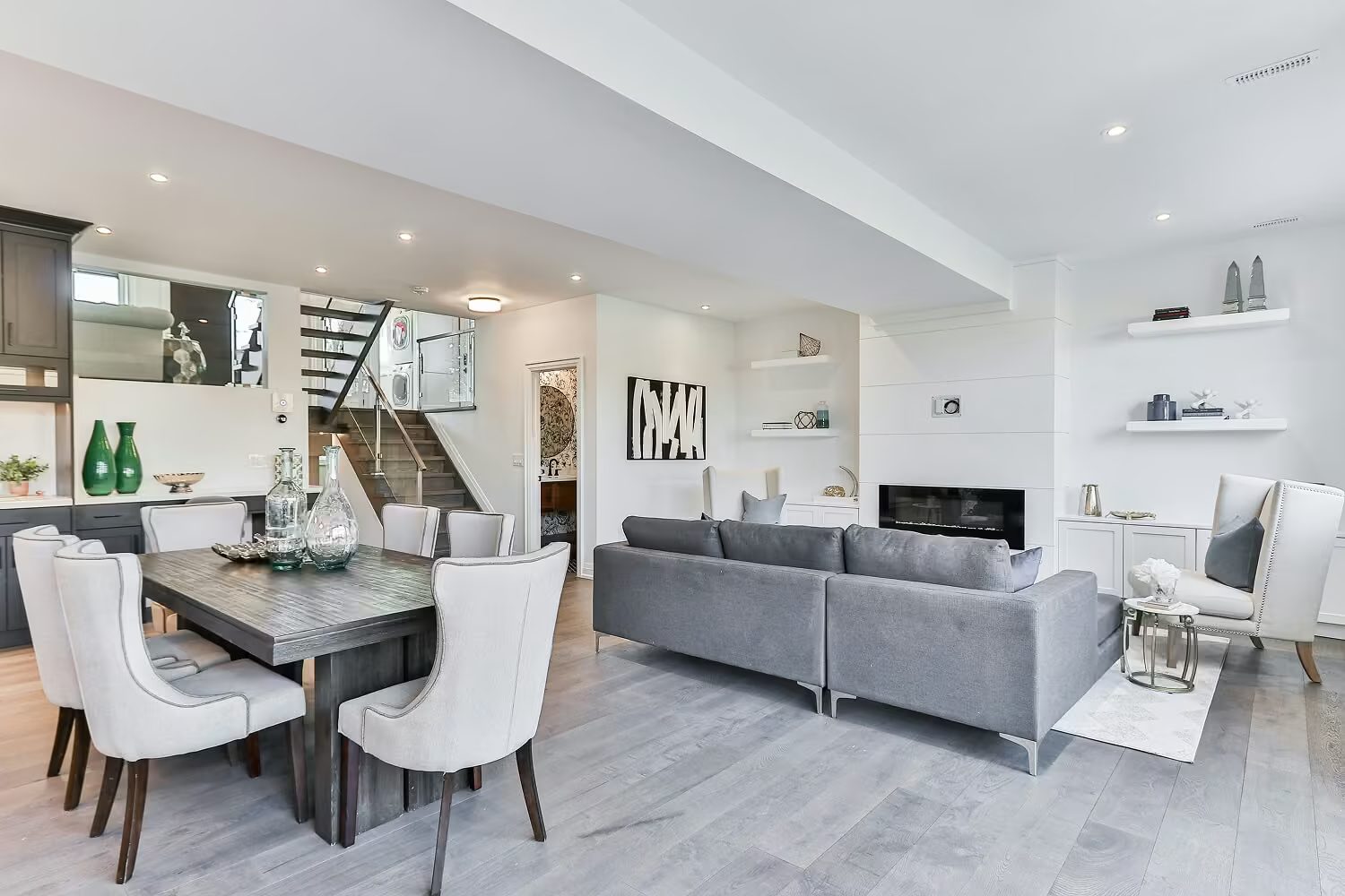 A bright, spotless open-plan living and dining room with light wood floors